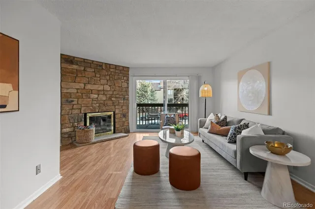a living room with fireplace furniture and a wooden floor