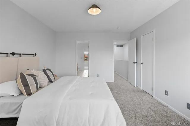 a bedroom with bed and a window