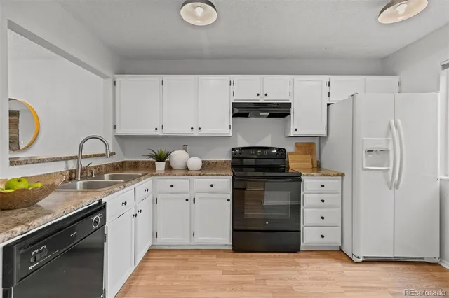 a kitchen with stainless steel appliances a stove sink and cabinets