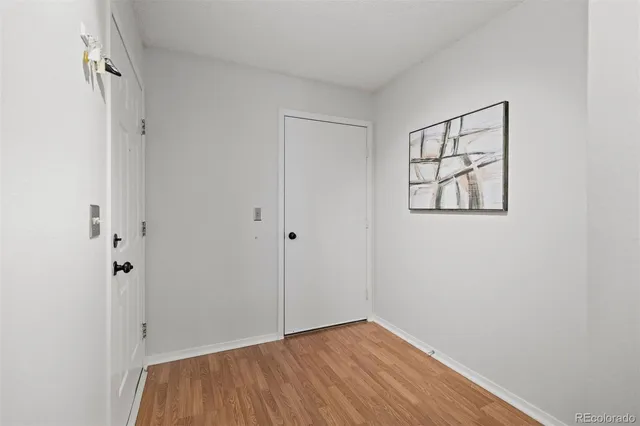 a view of an empty room with closet