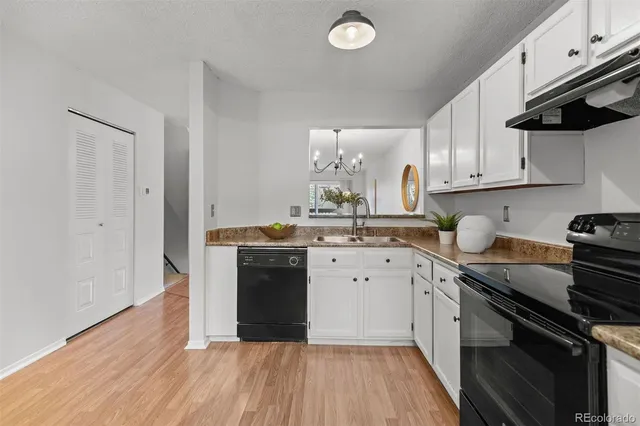 a kitchen with a sink stove and cabinets