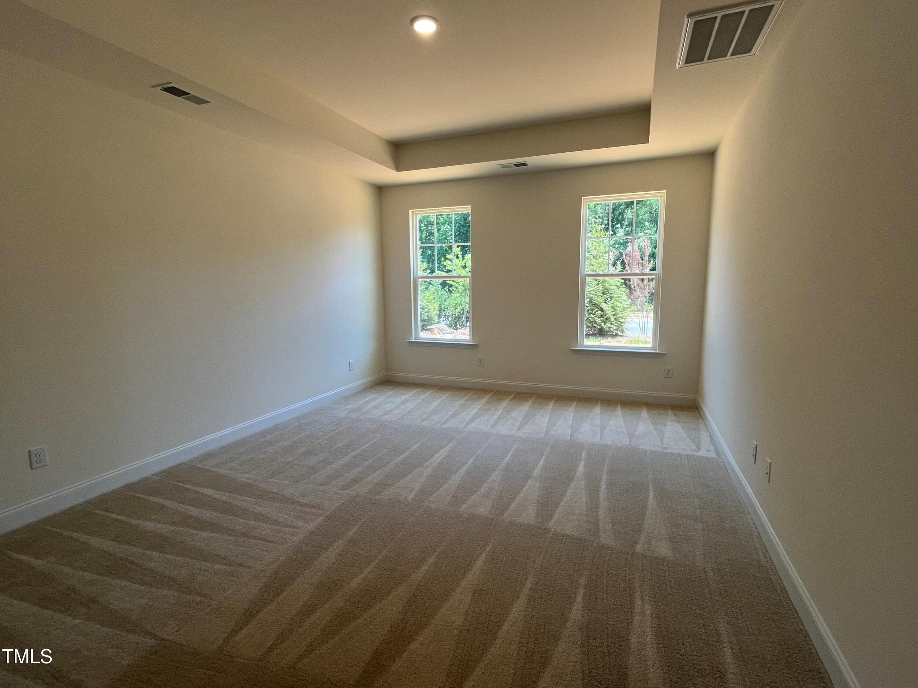 798 Old Station Pointe Angier, NC 27501 - Photo 9 of 19 an empty room with wooden floor and windows