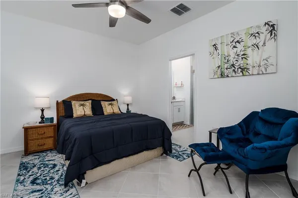 a bedroom with a bed couch and a window