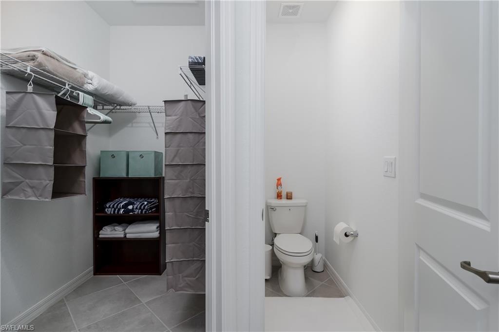2140 Dragonfruit Way Naples, FL 34120 - Photo 16 of 35 a bathroom with a toilet and shower