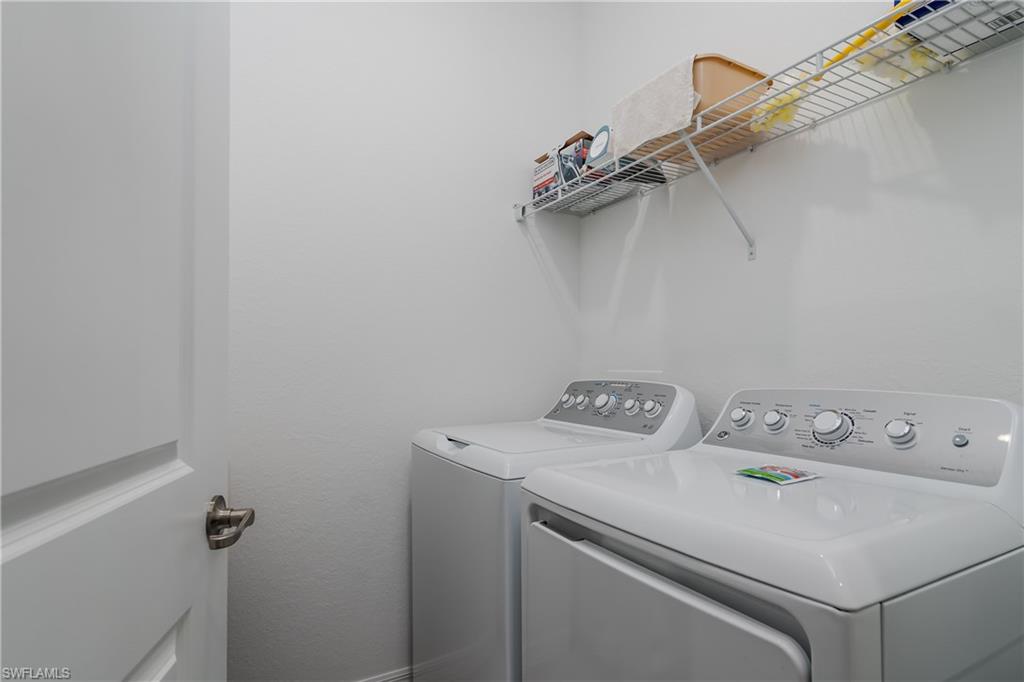 2140 Dragonfruit Way Naples, FL 34120 - Photo 23 of 35 a utility room with dryer and washer