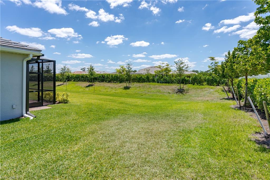 2140 Dragonfruit Way Naples, FL 34120 - Photo 32 of 35 a view of an outdoor space and basketball court
