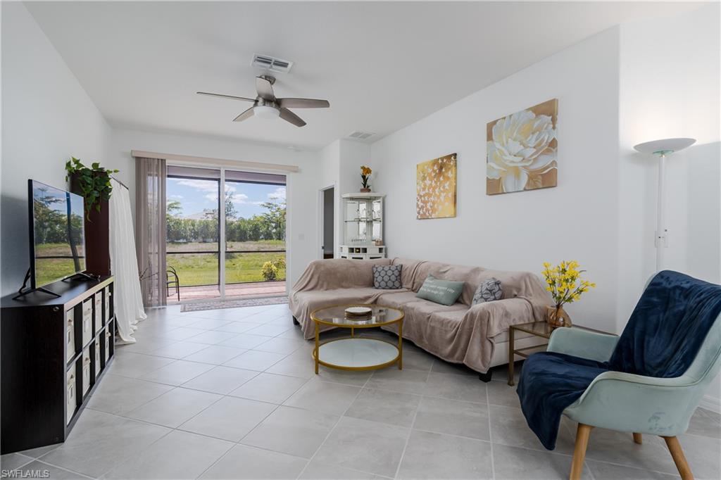 2140 Dragonfruit Way Naples, FL 34120 - Photo 7 of 35 a living room with furniture and a flat screen tv