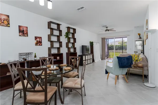 a view of a livingroom and a dining room with furniture window and wooden floor