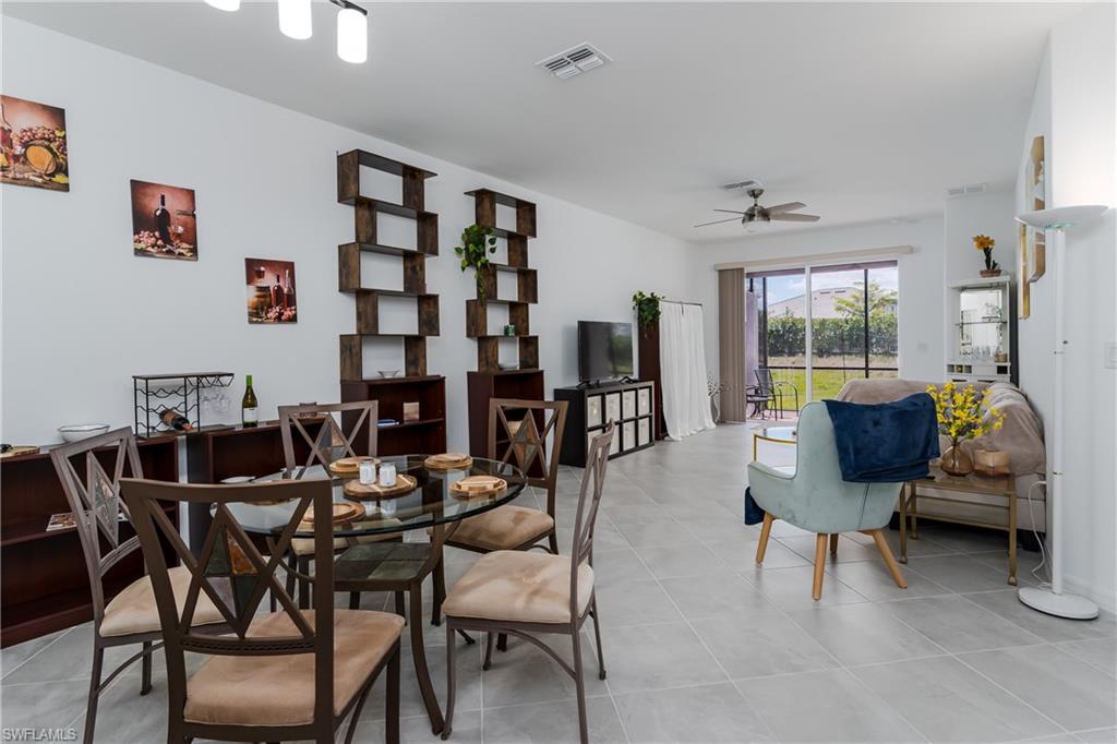 2140 Dragonfruit Way Naples, FL 34120 - Photo 10 of 35 a view of a livingroom and a dining room with furniture window and wooden floor