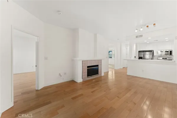 a view of a kitchen with a sink a fireplace and window