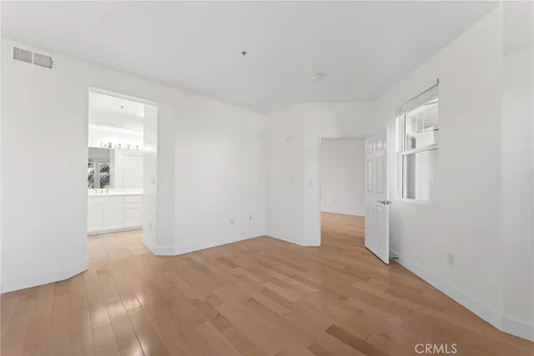 an empty room with windows and closet