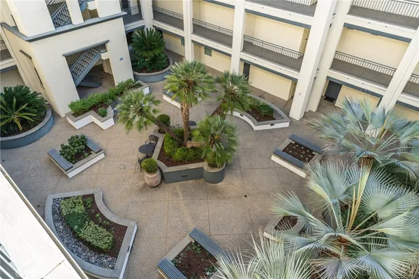 a view of backyard with outdoor seating and plants