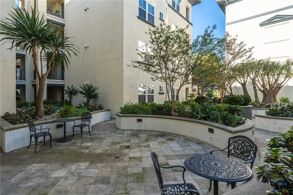 a view of a backyard with plants and outdoor seating