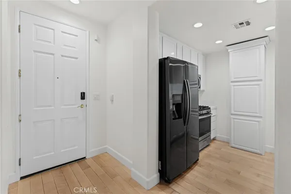 a view of a kitchen with refrigerator and cabinet