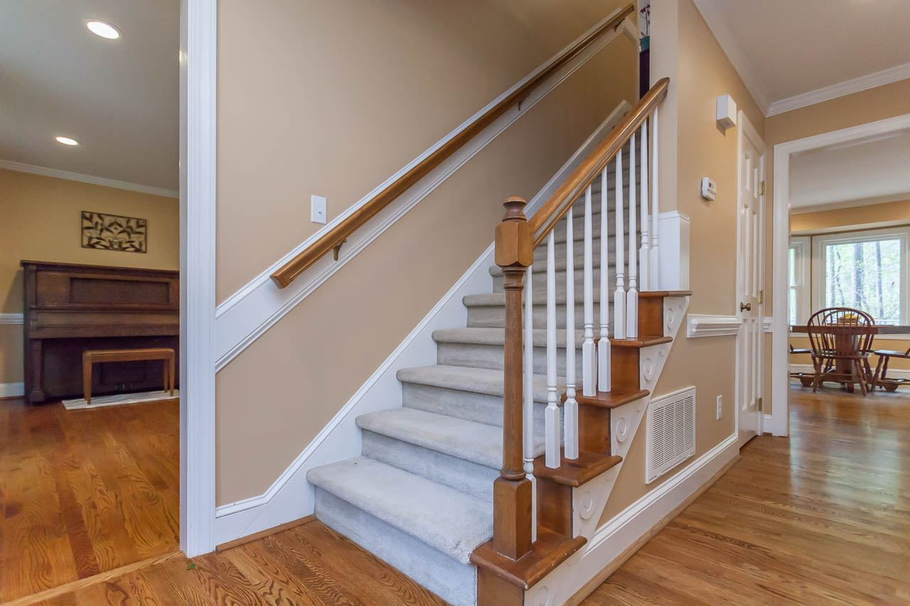 8805 Bickley Place Raleigh, NC 27613 - Photo 13 of 25 There is also a back staircase that leads to the bonus room on the second floor Front Staircase