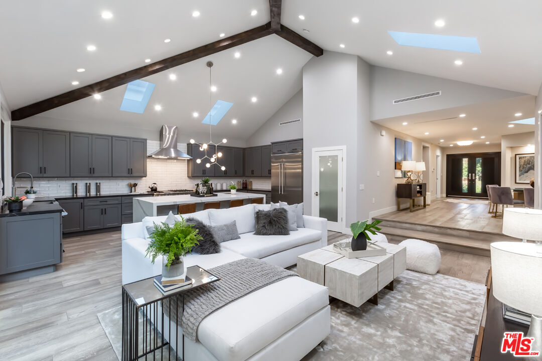 a living room with kitchen island furniture and kitchen view