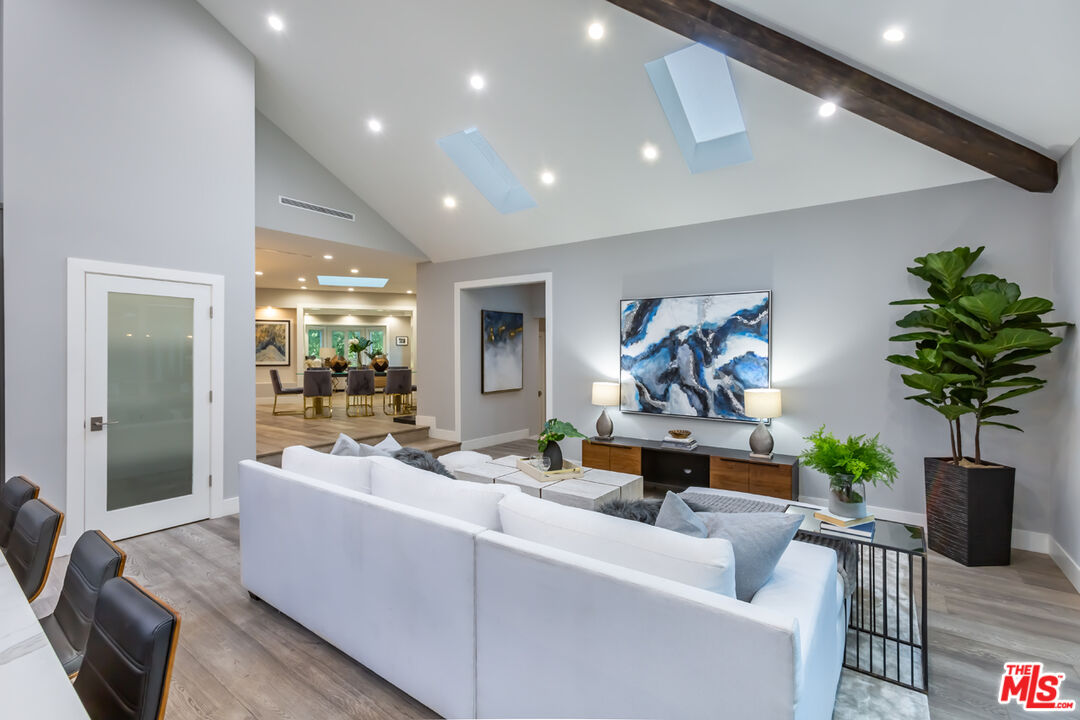 10700 Lindbrook Drive Los Angeles, CA 90024 - Photo 11 of 42 a living room with furniture potted plant and a large window