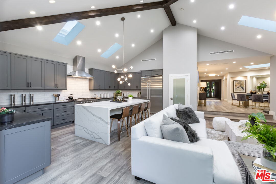 10700 Lindbrook Drive Los Angeles, CA 90024 - Photo 12 of 42 a large white kitchen with a large window and stainless steel appliances