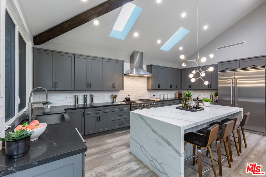 10700 Lindbrook Drive Los Angeles, CA 90024 - Photo 15 of 42 a kitchen with a stove a sink and a refrigerator