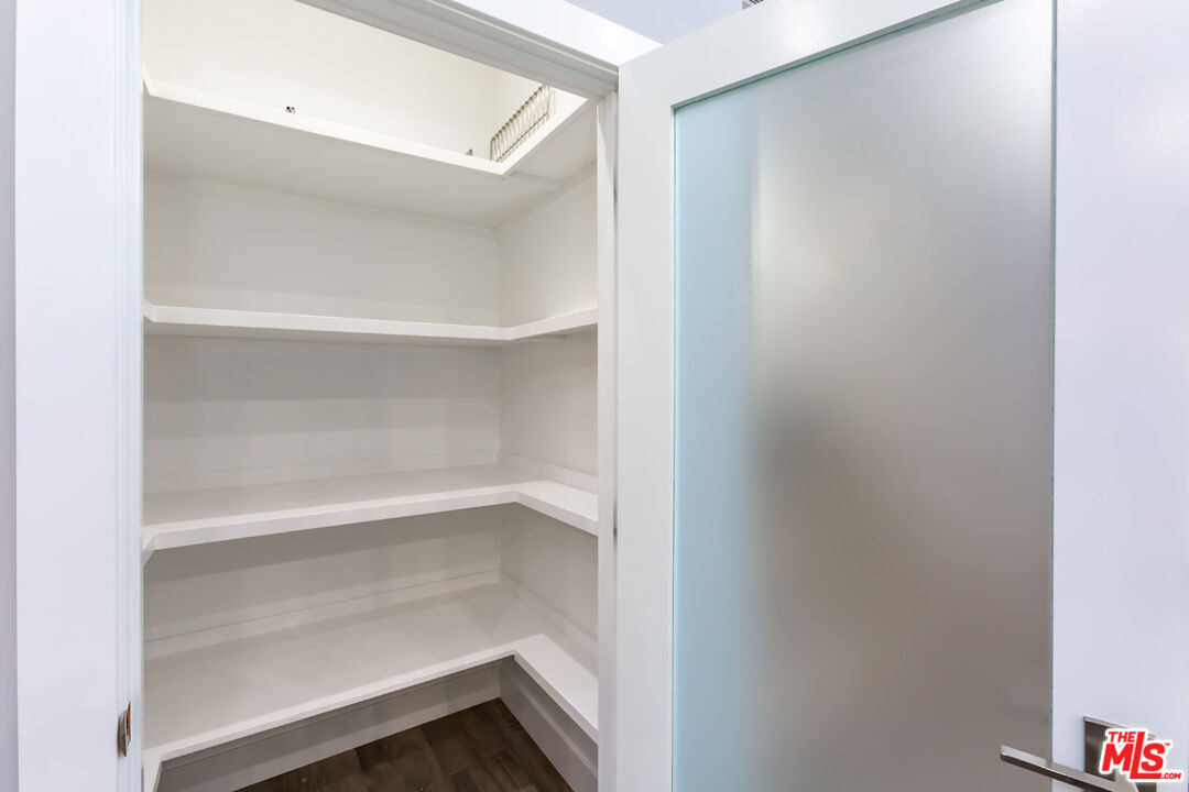 10700 Lindbrook Drive Los Angeles, CA 90024 - Photo 19 of 42 a view of walk in closet with empty racks