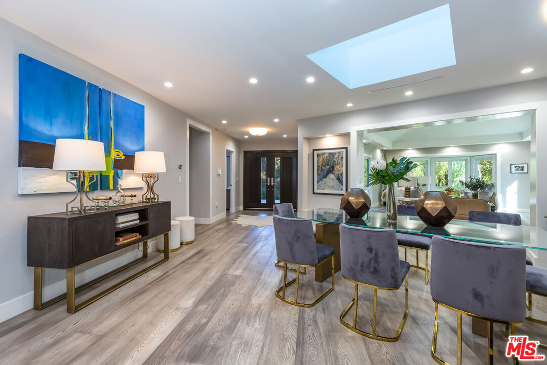 10700 Lindbrook Drive Los Angeles, CA 90024 - Photo 3 of 42 a living room with furniture a wooden floor and kitchen view