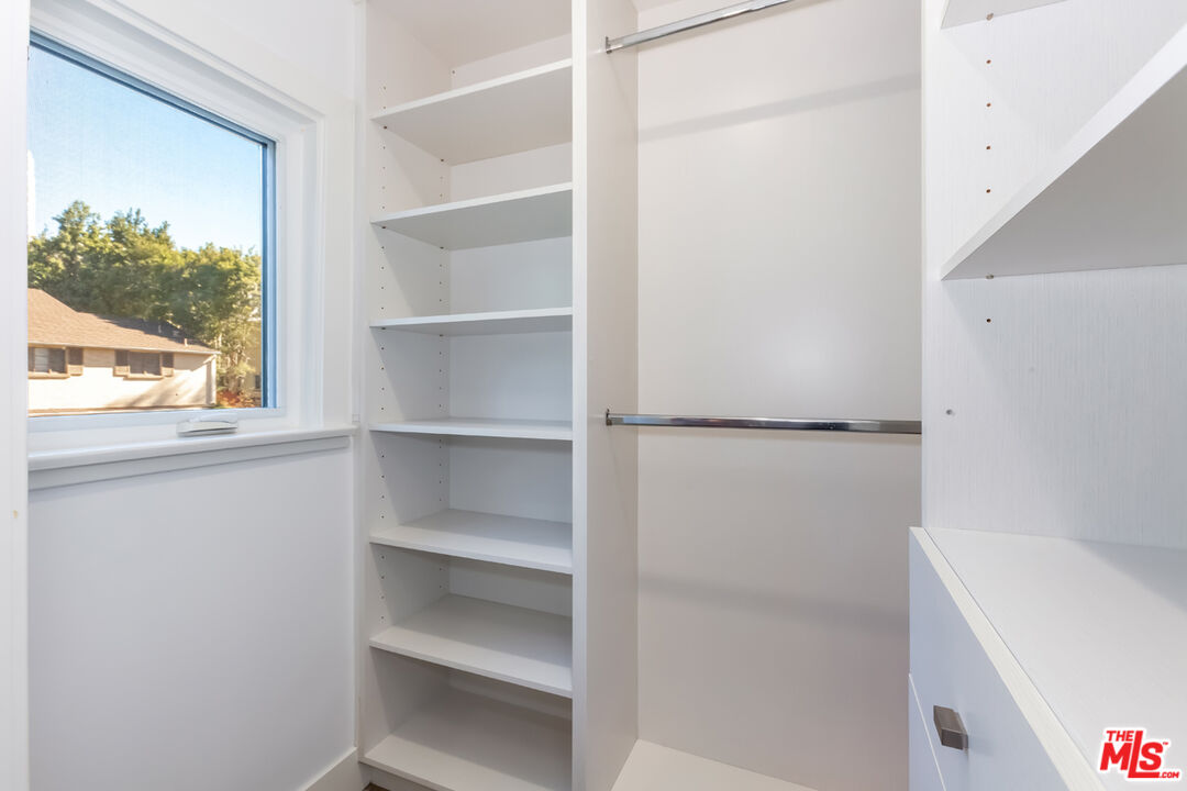 10700 Lindbrook Drive Los Angeles, CA 90024 - Photo 31 of 42 a view of walk in closet with empty racks