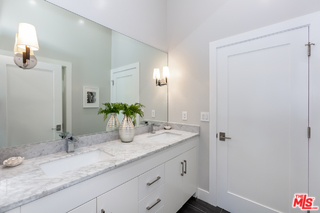 10700 Lindbrook Drive Los Angeles, CA 90024 - Photo 34 of 42 a bathroom with a granite countertop sink and a mirror