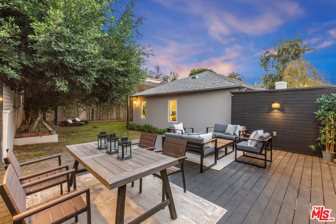 10700 Lindbrook Drive Los Angeles, CA 90024 - Photo 41 of 42 a view of a patio with a dining table and chairs with wooden floor and fence