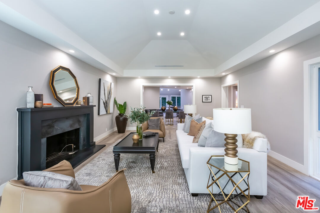 10700 Lindbrook Drive Los Angeles, CA 90024 - Photo 6 of 42 a living room with furniture a fireplace and a potted plant
