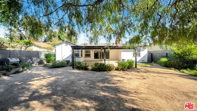 a view of a house with a tree in the background