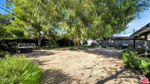a view of a backyard with sitting area