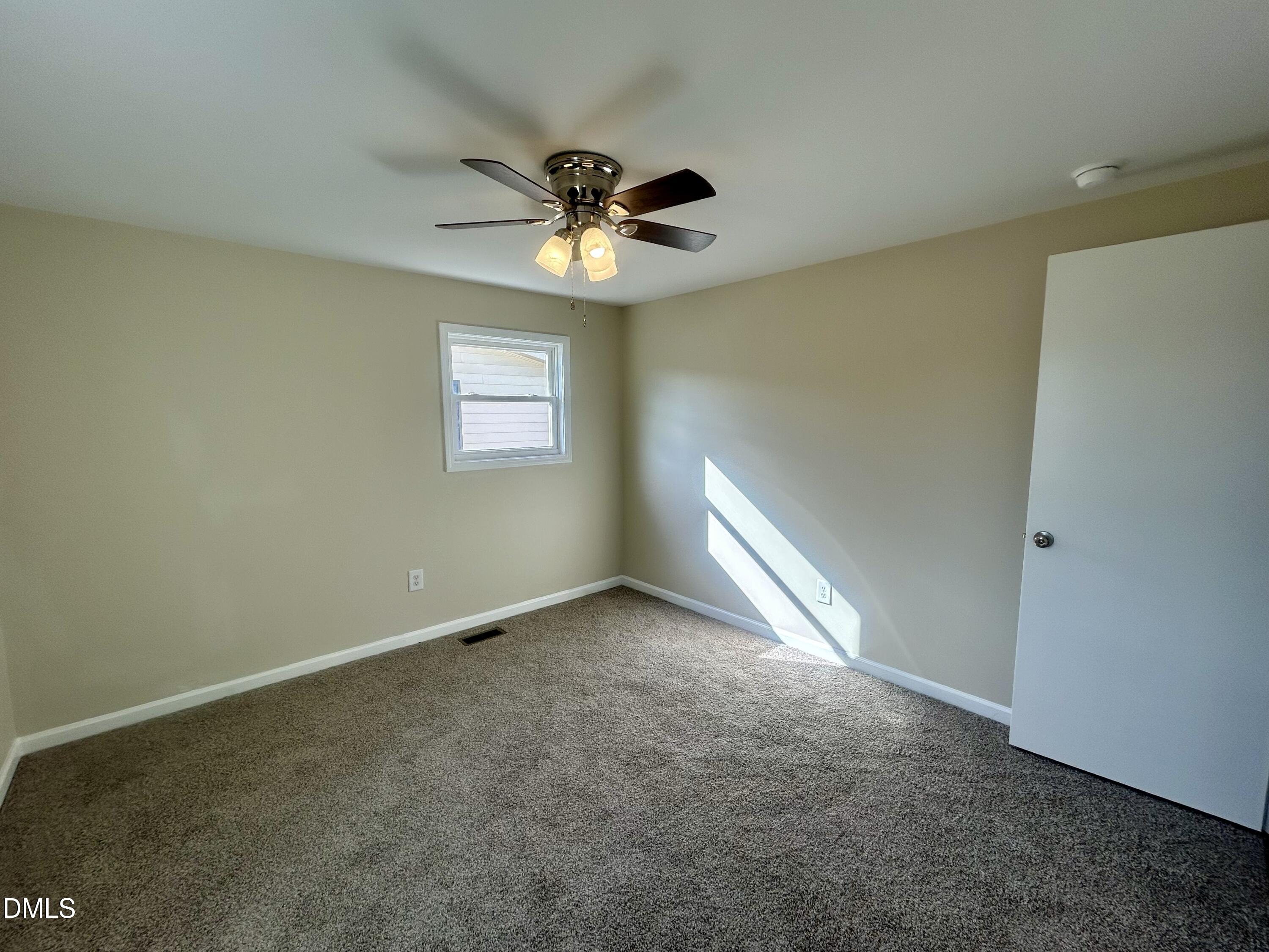 403 South Market Street Benson, NC 27504 - Photo 13 of 18 an empty room with windows and fan