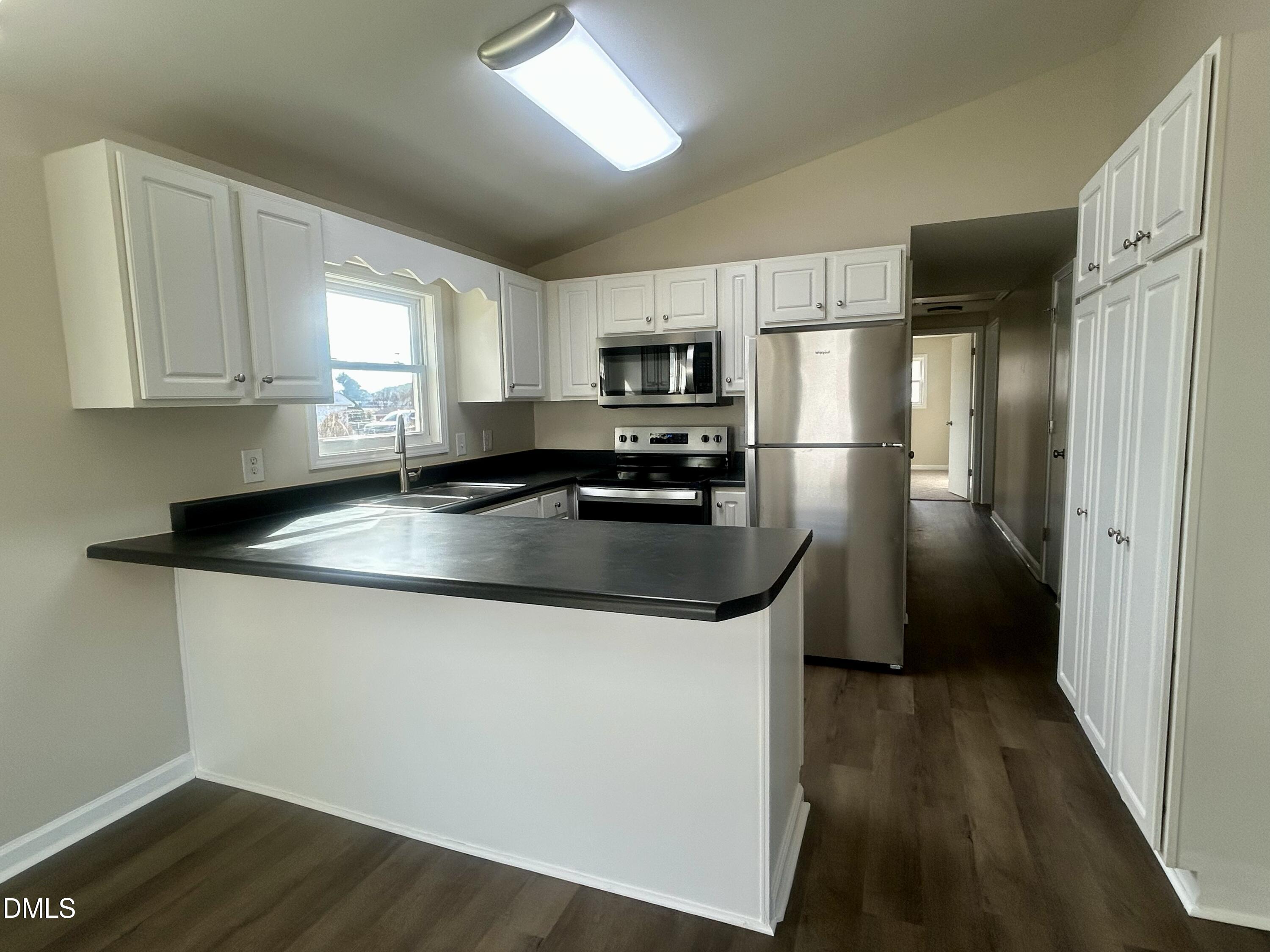 403 South Market Street Benson, NC 27504 - Photo 5 of 18 a kitchen with granite countertop a refrigerator sink and stove