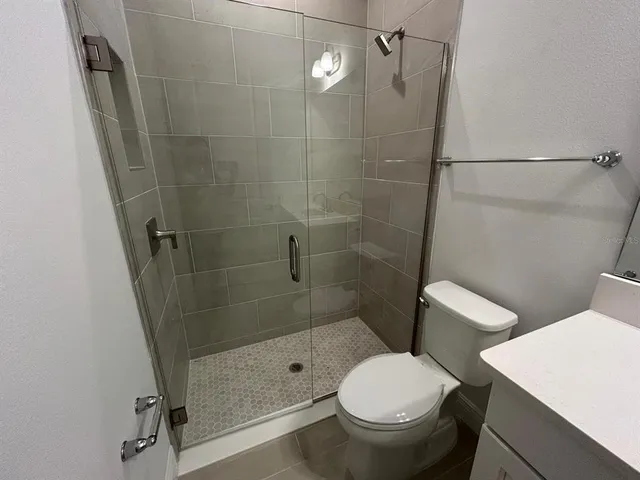 a bathroom with a toilet and a shower