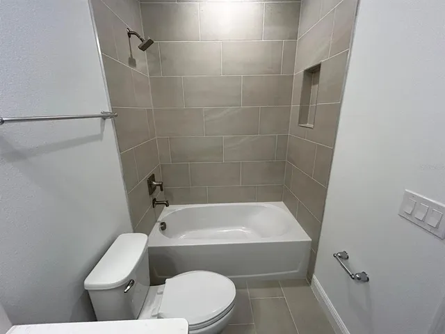 a bathroom with a toilet and bathtub