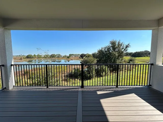 a view of balcony with wooden floor and fence