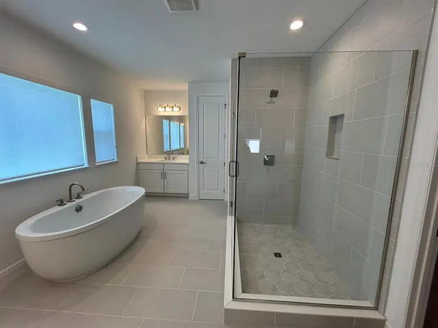 a bathroom with a bathtub and shower