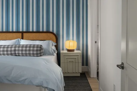 a bedroom with a bed and cabinets