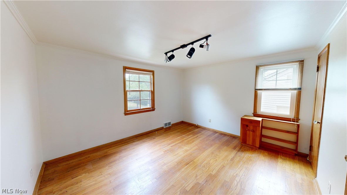 1508 Edgefield Road Lyndhurst, OH 44124 - Photo 11 of 28 Unfurnished room featuring plenty of natural light, light wood-type flooring, and rail lighting