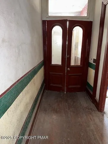 a view of entry way with wooden door