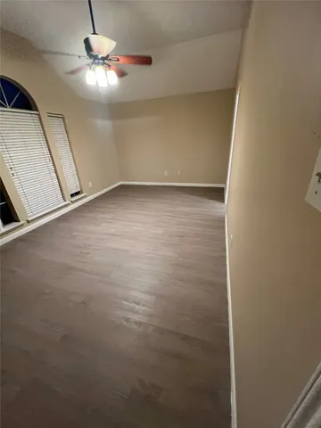 wooden floor in an empty room with a mirror