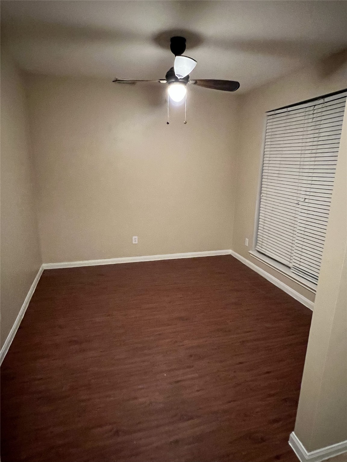 4018 Longway Estates Court Fresno, TX 77545 - Photo 4 of 20 a view of an empty room with wooden floor and a ceiling fan
