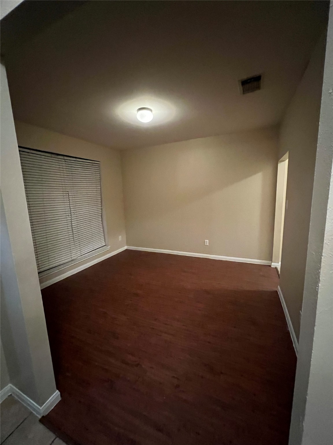 4018 Longway Estates Court Fresno, TX 77545 - Photo 5 of 20 en empty room with wooden floor and windows