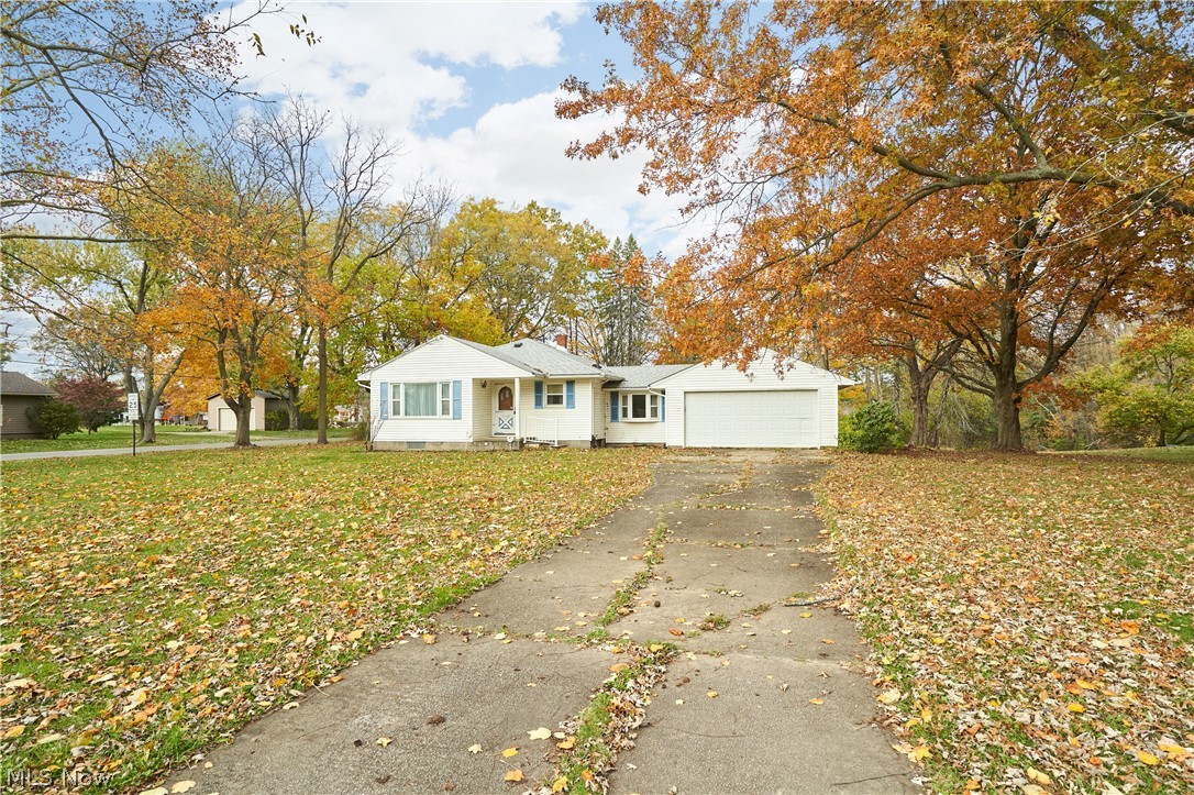 2941 Sweitzer Road Uniontown, OH 44685 - Photo 16 of 16 View of front of house featuring asphalt driveway, crawl space, a front yard, and an attached garage