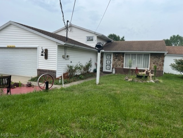 4170 Abbe Road North Sheffield Lake, OH 44054 - Photo 1 of 1 Front view of house with a garage and a yard.
