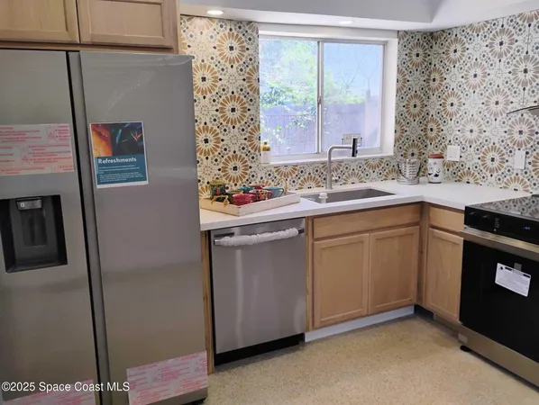 a kitchen with stainless steel appliances granite countertop a sink and cabinets