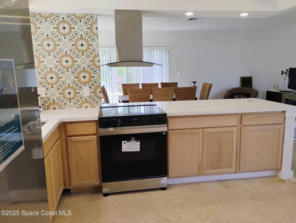 a kitchen with a stove and a refrigerator