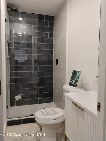 a bathroom with a toilet and a shower