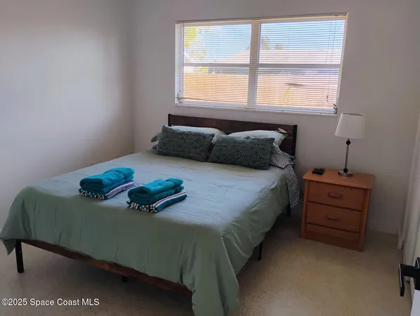 a bedroom with a bed and window
