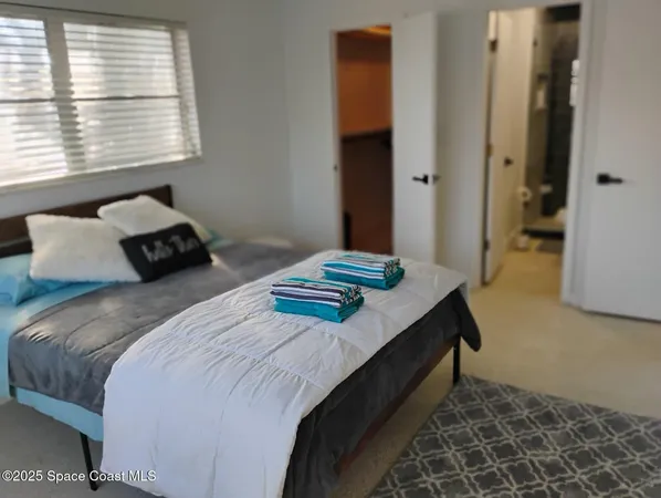 a bedroom with bed and window